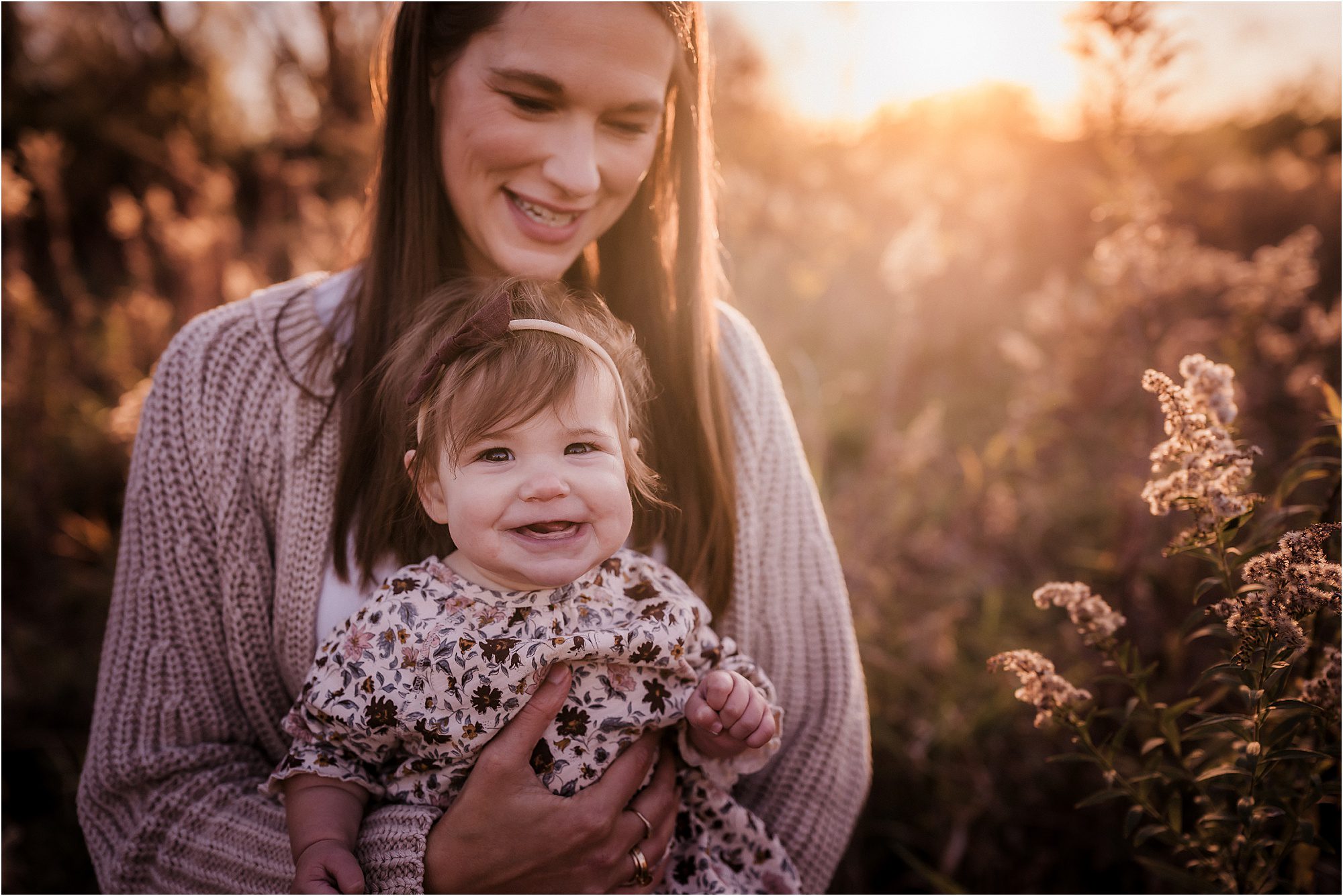 Madison WI family photographer candid family walking at sunset in open field